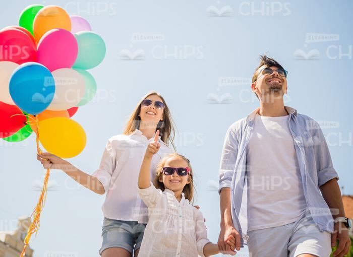 Handsome Young Family With Bunch Of Balloons Stock Photo
