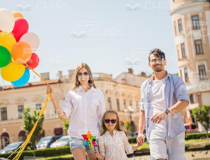 Young Family Walking Through The City Stock Photo