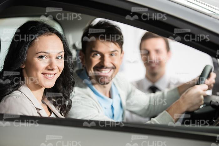Excited Couple Sitting In Vehicle Stock Photo