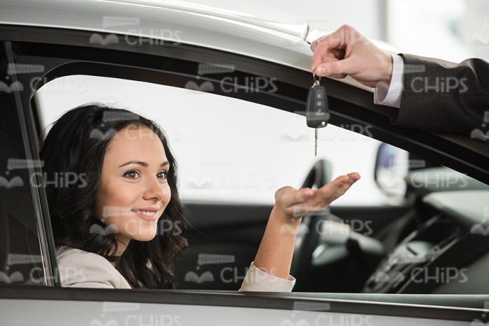 Nice Woman Sitting In Her New Car While Taking Keys Stock Photo