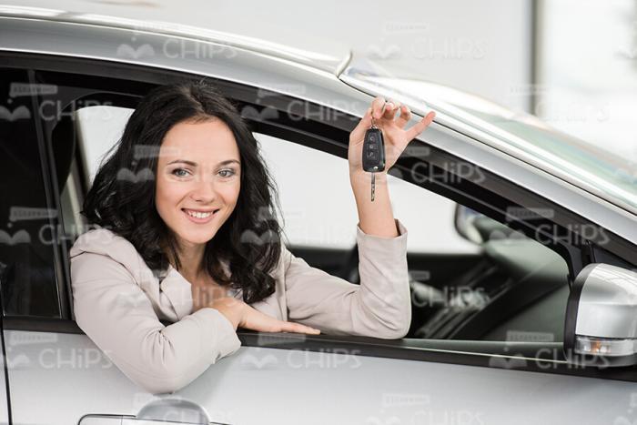 Stock Photo Of Young Woman Smiling While Sitting In New Car