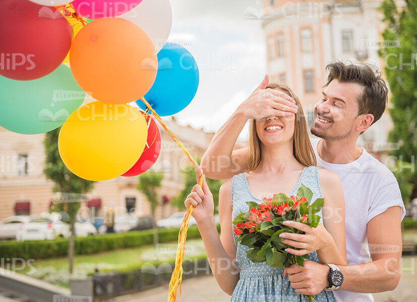 Young Man Covering Woman's Eyes Stock Photo Young Man Covering Woman's Eyes Stock Photo