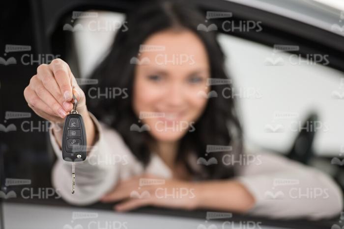 Smiling Lady Holds Keys With Right Hand While Sits In Her New Car Stock Photo