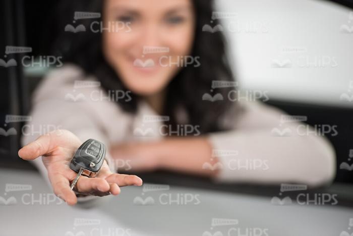 Young Woman Giving Car Keys To Someone Stock Photo