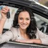 Smiling Woman Sits In Car And Shows Keys Stock Photo