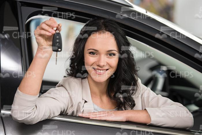 Smiling Woman Sits In Car And Shows Keys Stock Photo