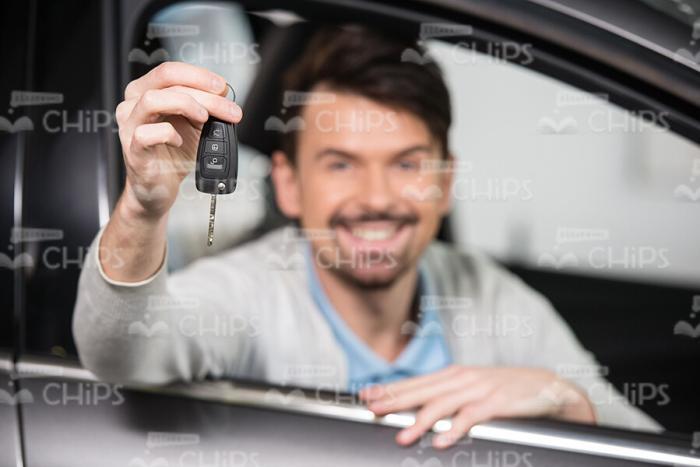 Happy Man Sitting In New Car And Showing Keys Stock Photo