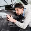 Man Carefully Inspecting The Car Body Stock Photo
