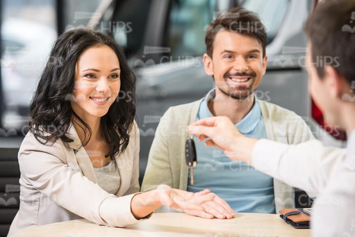Car Salesman Gives Keys To Buyers Stock Photo