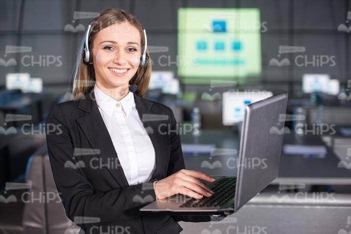 Businesswoman Talking With Clients By Headset Stock Photo