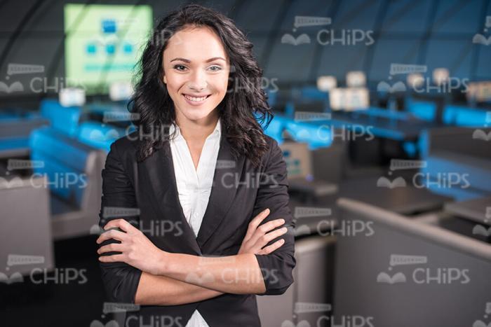 Smiling Business Lady Standing With Arms Crossed Stock Photo