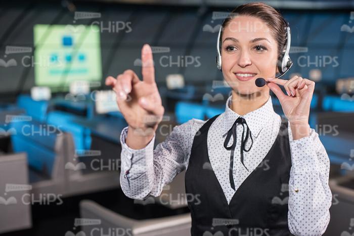 Businesswoman With Headset Pointing Forward Stock Photo