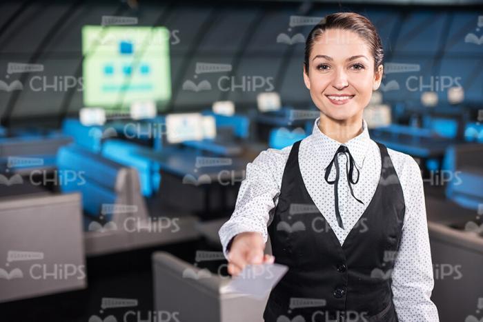 Smiling Businesswoman Gives Card Sample Stock Photo