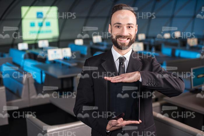 Presentable Businessman Holding Tablet Stock Photo