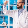 Bearded Scientist Holding a Test Tube Stock Photo