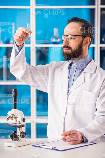 Bearded Scientist Holding a Test Tube Stock Photo