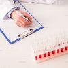 Researcher's Hand Writing On Clipboard Stock Photo
