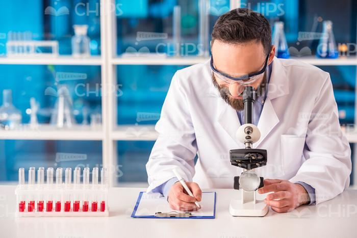 Male Researcher Using Microscope Stock Photo