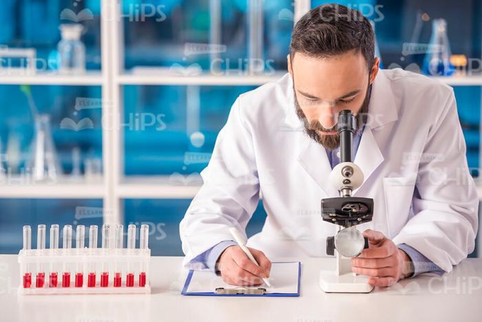 Medical Scientist Working With Microscope Stock Photo