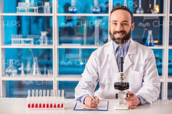Pleased Scientist Working At Lab Stock Photo