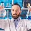 Lab Researcher Looking On Flasks Stock Photo