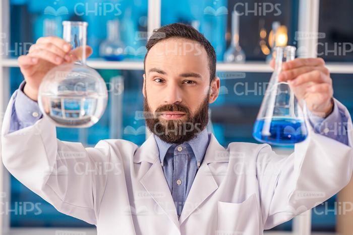 Lab Researcher Looking On Flasks Stock Photo