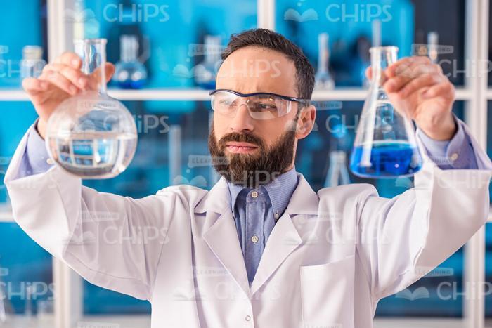 Medical Scientist Working With Flasks Stock Photo