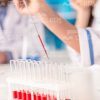 Group Of Scientists Working With Test Tubes Stock Photo