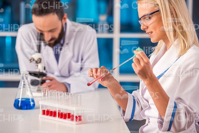 Woman Filling Test Tube Stock Photo