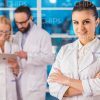 Pretty Young Woman In White Lab Coat Stock Photo