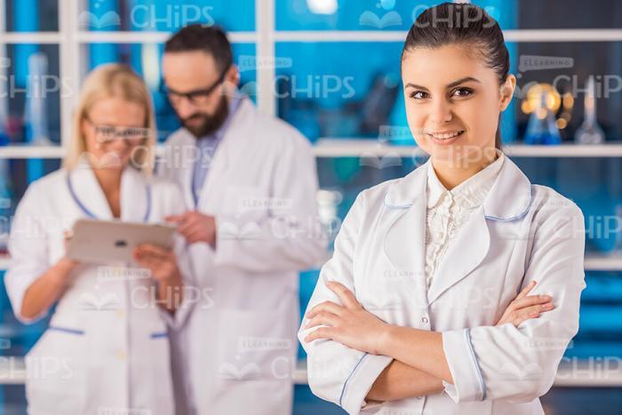 Pretty Young Woman In White Lab Coat Stock Photo