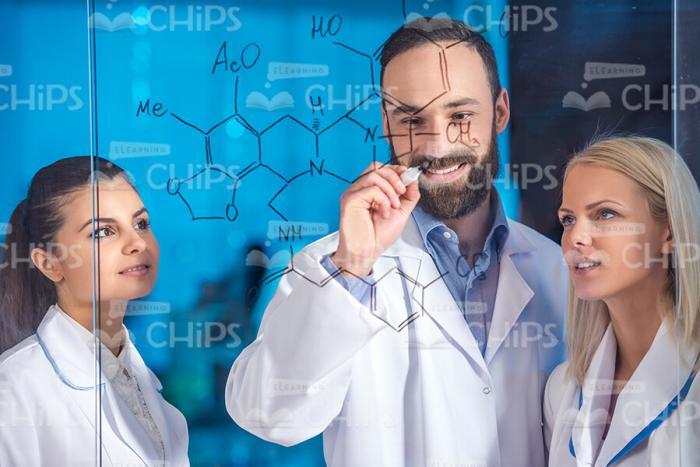 Scientist Writing Chemical Formula Stock Photo