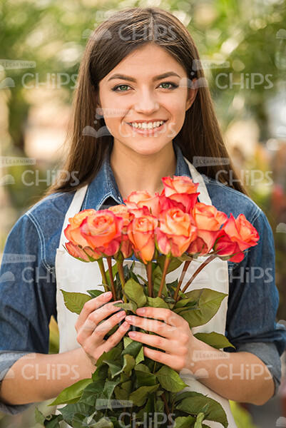 Female Gardener With Flowers Stock Photo