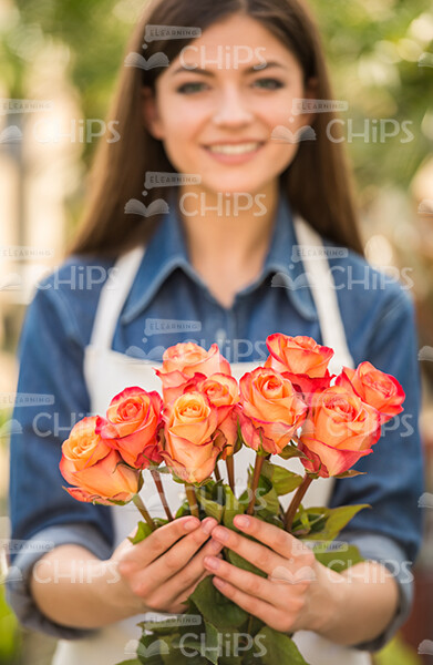 Female Young Gardener Holding Flowers Stock Photo