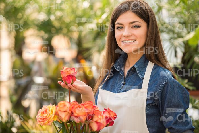 Nice Female Gardener With Bouquet Of Flowers Stock Photo