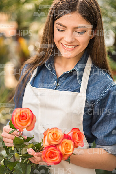 Smiling Woman With Flowers Stock Photo
