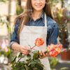 Cute Young Gardener Holds Flowers Stock Photo