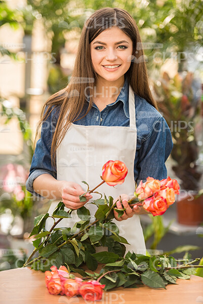 Cute Young Gardener Holds Flowers Stock Photo