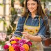 Pretty Smiling Gardener With Basket Of Flowers Stock Photo