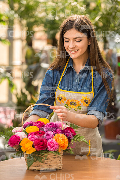 Pretty Smiling Gardener With Basket Of Flowers Stock Photo