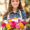 Woman Gardener Holding Basket Of Flowers Stock Photo