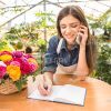 Smiling Woman Accepts The Order By Phone Stock Photo