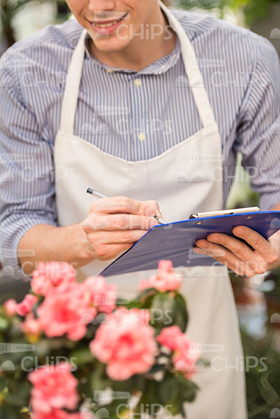 Man's Hands Holding Clipboard Stock Photo