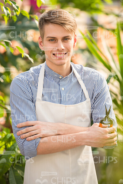 Smiling Gardener Holding Scissors Stock Photo