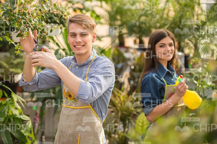 Young Man And Woman Working In Garden Stock Photo