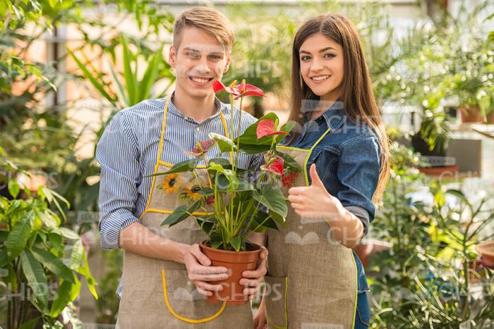 Two Young Gardeners Holding Plant Pot Stock Photo