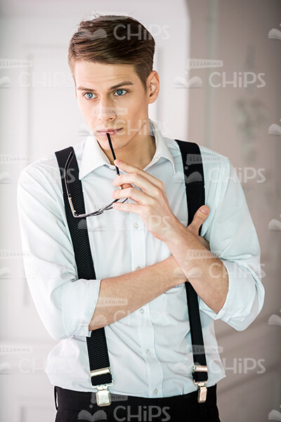 Thoughful Man Holds Glasses Stock Photo