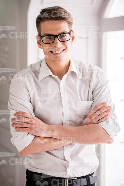 Young Businessman Crosses Arms Stock Photo