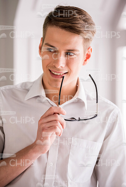 Young Man With Stylish Haircut Holding Glasses Stock Photo Young Man With Stylish Haircut Holding Glasses Stock Photo