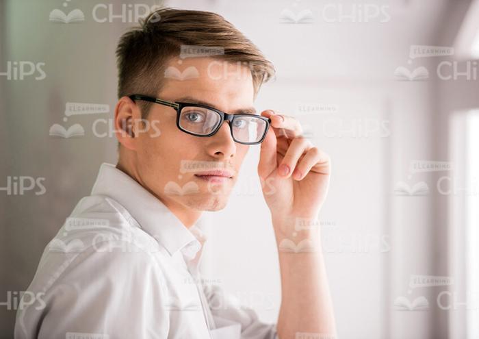 Handsome Young Businessman Turns To Camera Stock Photo